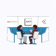 Why "Human-in-the-Loop" is the Only Way to Scale Enterprise AI Dos profesionales están sentados ante una consola de control azul, hablando sobre una tableta, con el logotipo de AdCP en la pared.